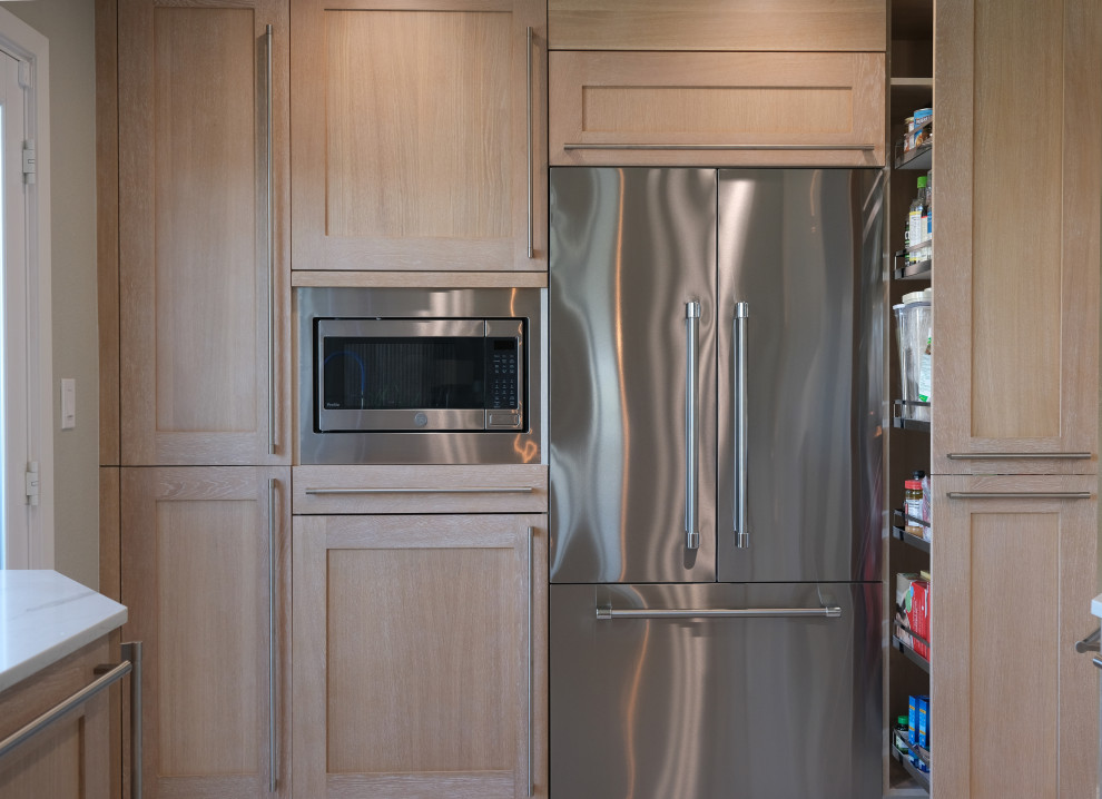 Small transitional u-shaped ceramic tile and beige floor open concept kitchen photo in San Francisco with a double-bowl sink, recessed-panel cabinets, light wood cabinets, quartz countertops, white backsplash, quartz backsplash, stainless steel appliances and white countertops