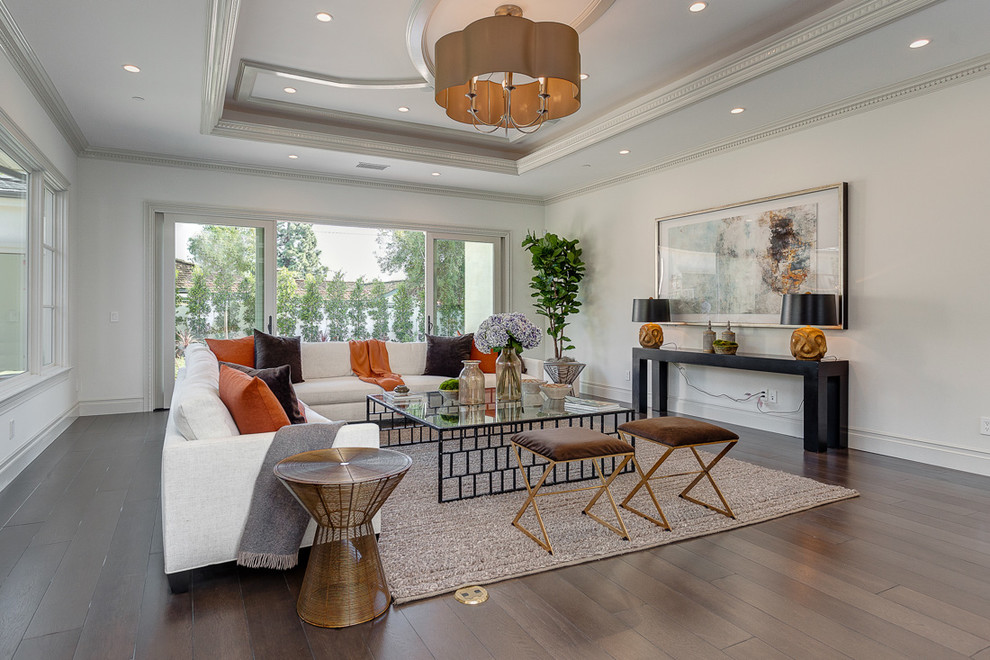 This is an example of a transitional living room in Los Angeles with white walls and medium hardwood floors.