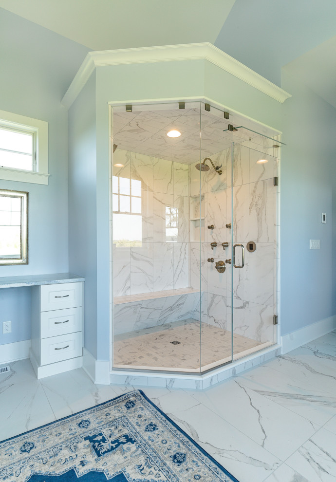 Photo of a large arts and crafts master bathroom in Baltimore with blue walls, marble floors, white floor, a shower seat and a built-in vanity.