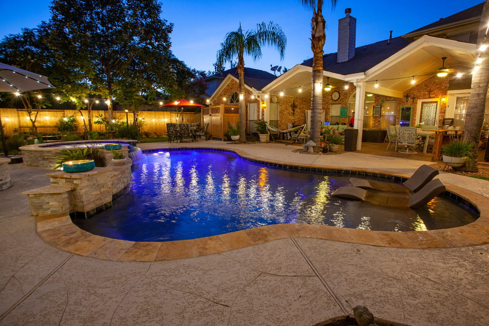 Photo of a mid-sized asian backyard kidney-shaped pool in Houston with decking.