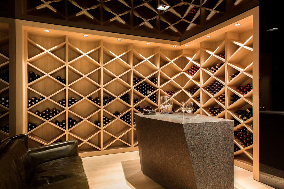Photo of a contemporary wine cellar in Other with light hardwood floors.