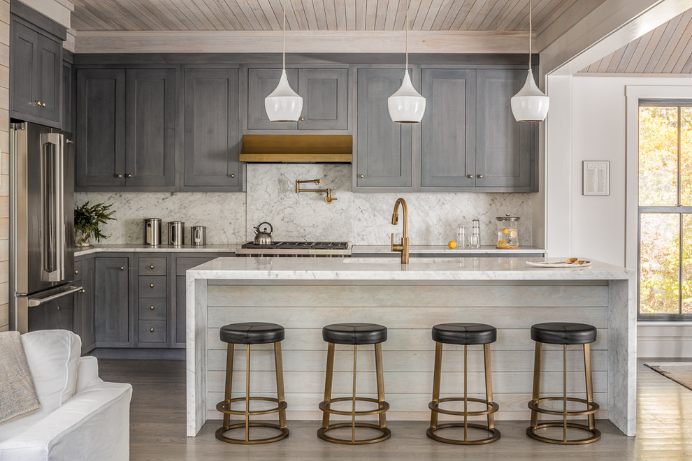 Design ideas for a transitional l-shaped kitchen in Portland Maine with shaker cabinets, grey cabinets, white splashback, stone slab splashback, stainless steel appliances, dark hardwood floors and with island.