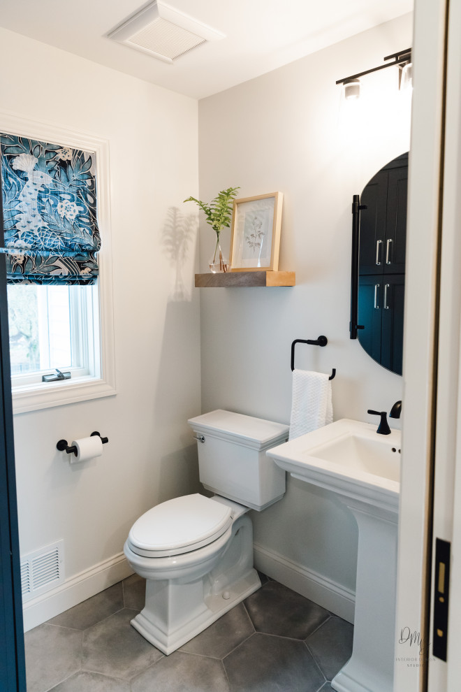Traditional powder room in Other with a two-piece toilet, white walls, porcelain floors, a pedestal sink, grey floor and white benchtops.