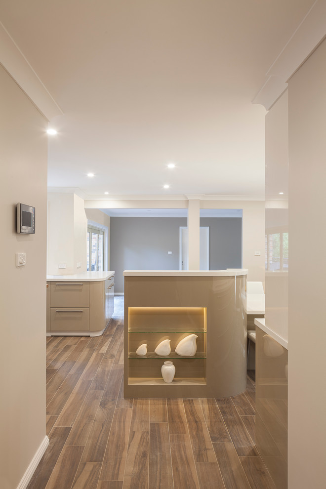 Inspiration for an expansive contemporary u-shaped eat-in kitchen in Sydney with an undermount sink, flat-panel cabinets, green cabinets, quartz benchtops, brown splashback, glass sheet splashback, stainless steel appliances, ceramic floors and multiple islands.