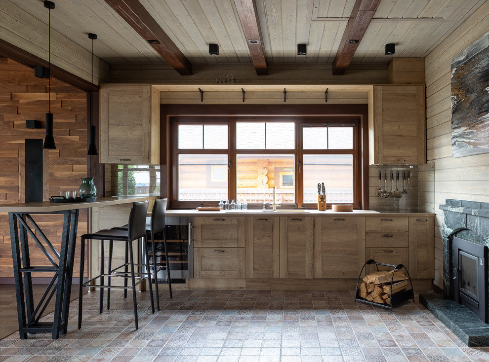 This is an example of a country kitchen in Moscow with shaker cabinets, light wood cabinets, multi-coloured floor, beige benchtop, a drop-in sink, window splashback and a peninsula.