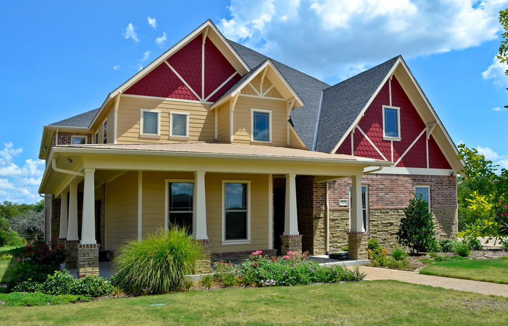 Photo of a traditional two-storey beige exterior in Dallas with mixed siding.