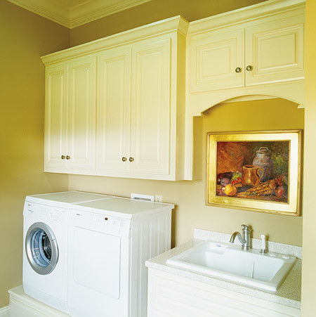 Mid-sized traditional single-wall laundry room in Nashville with a drop-in sink, raised-panel cabinets, white cabinets, laminate benchtops, beige walls and a side-by-side washer and dryer.