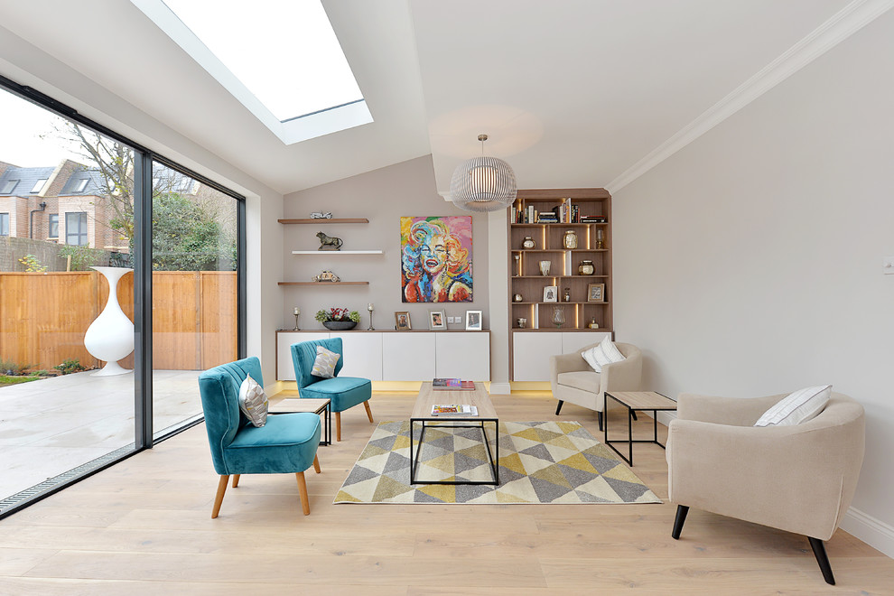 Photo of a mid-sized contemporary formal enclosed living room in London with grey walls, light hardwood floors and beige floor.