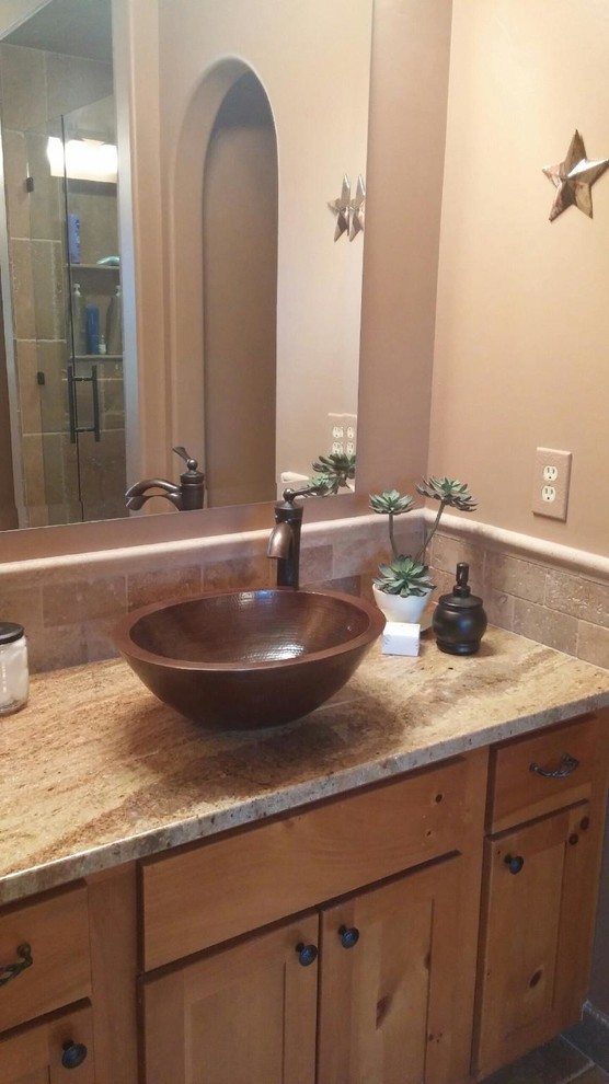 This is an example of a large traditional master bathroom in Wichita with a vessel sink, shaker cabinets, light wood cabinets, granite benchtops, beige tile, stone tile and beige walls.