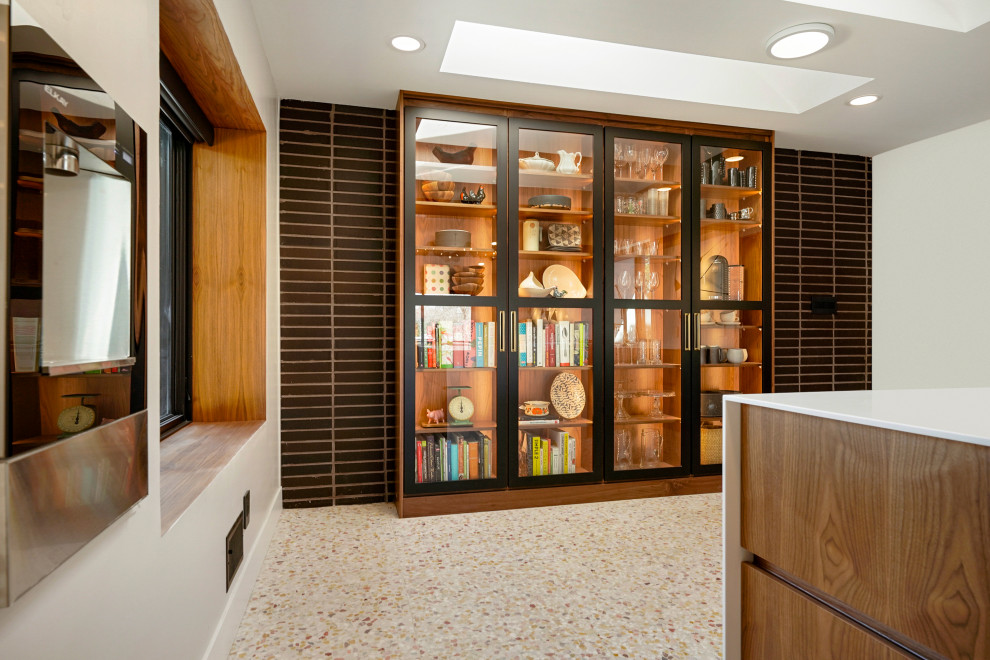 Design ideas for an expansive midcentury single-wall kitchen pantry in Denver with an integrated sink, flat-panel cabinets, medium wood cabinets, engineered stone countertops, white splashback, integrated appliances, multiple islands, white worktops and exposed beams.