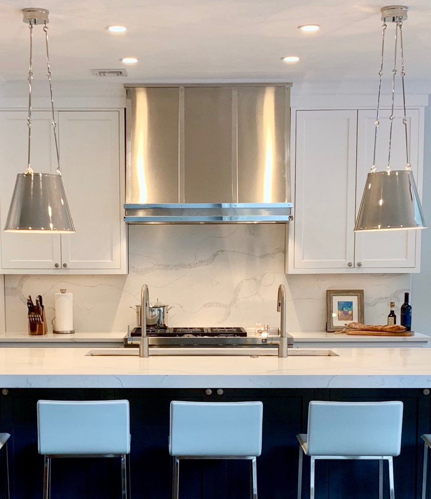 Example of a large transitional l-shaped medium tone wood floor and brown floor eat-in kitchen design with an undermount sink, recessed-panel cabinets, white cabinets, quartz countertops, white backsplash, stone slab backsplash, stainless steel appliances, an island and white countertops