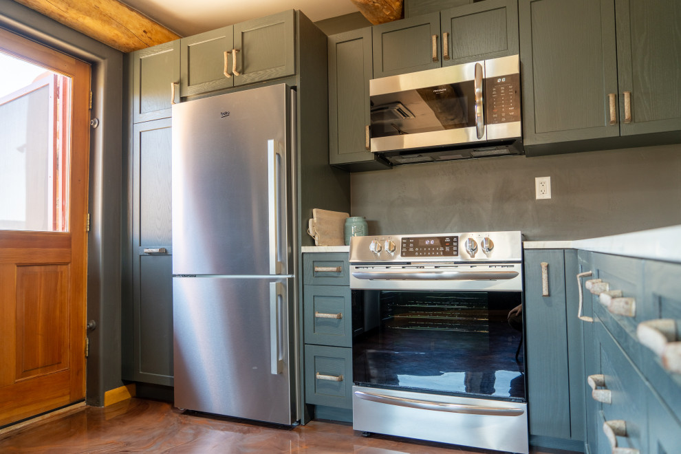 Kitchen - transitional concrete floor kitchen idea with shaker cabinets, blue cabinets and stainless steel appliances