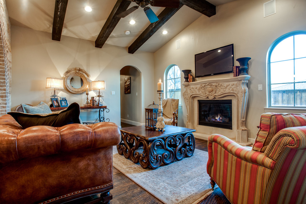 Design ideas for a large traditional open concept family room in Dallas with white walls, medium hardwood floors, a standard fireplace, a stone fireplace surround and a wall-mounted tv.