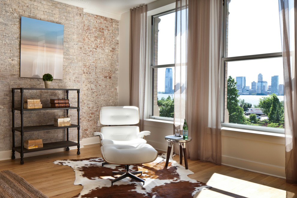 Large urban loft-style light wood floor living room photo in New York with white walls