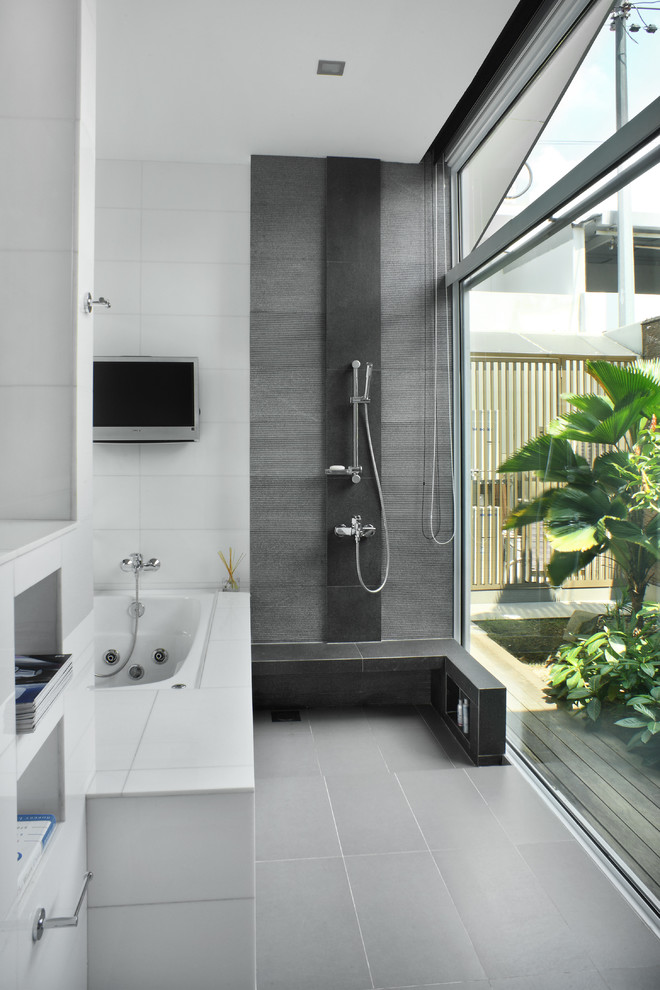 This is an example of a mid-sized modern master bathroom in Singapore with an undermount sink, a hot tub, an open shower, white tile, porcelain tile, white walls, porcelain floors and an open shower.