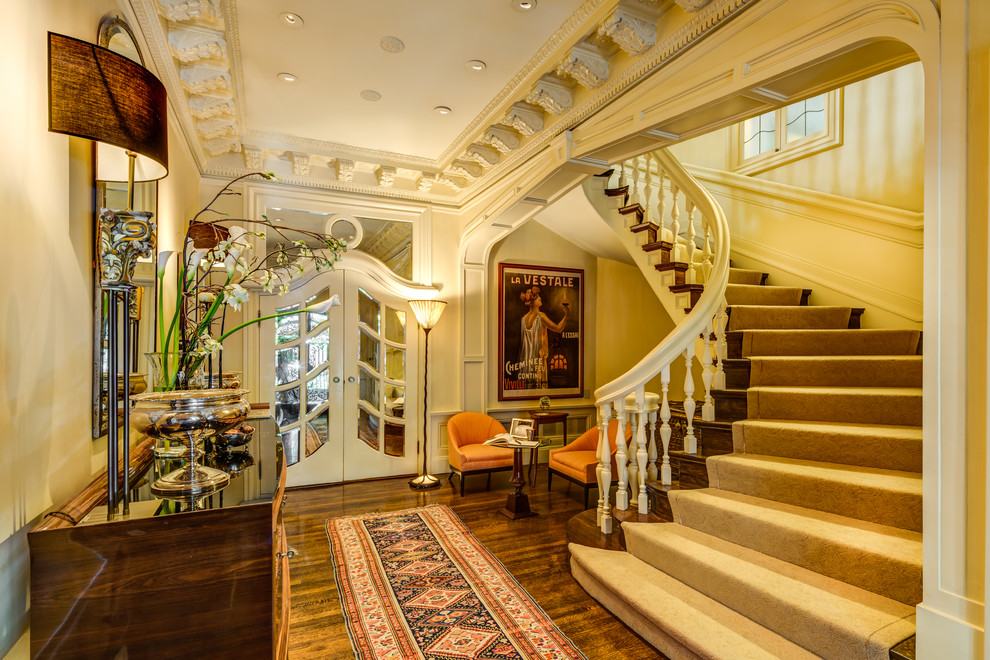 Inspiration for a traditional foyer in San Francisco with yellow walls and dark hardwood floors.