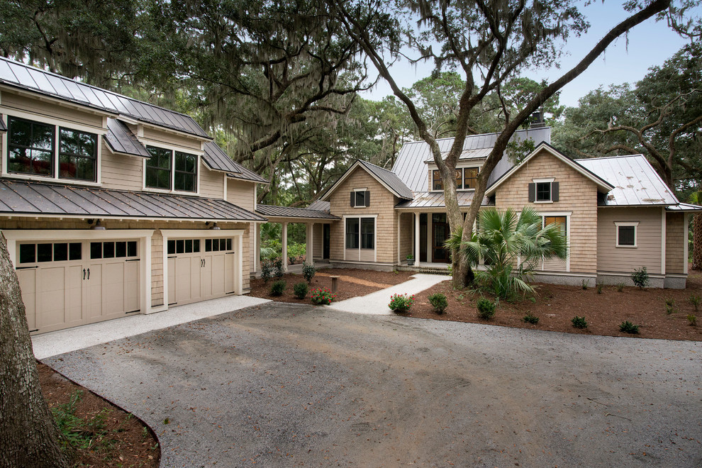 This is an example of a large beach style two-storey beige exterior in Charleston with wood siding.