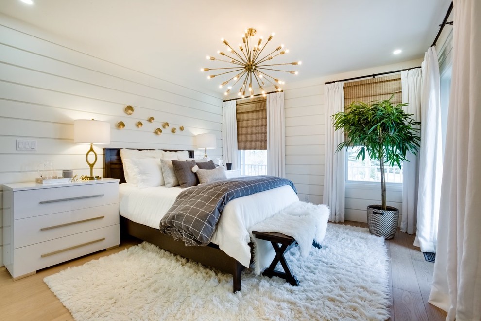 Inspiration for a mid-sized country master bedroom in Toronto with white walls, light hardwood floors, no fireplace and beige floor.