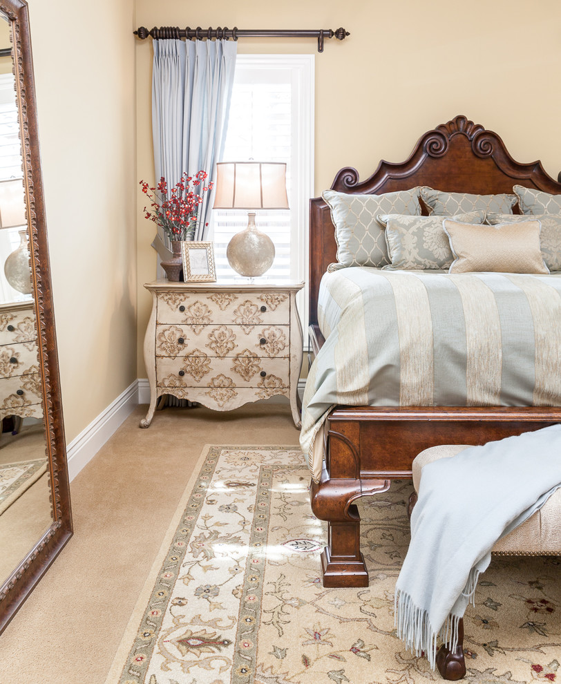 Inspiration for a traditional master bedroom in Sacramento with beige walls and carpet.