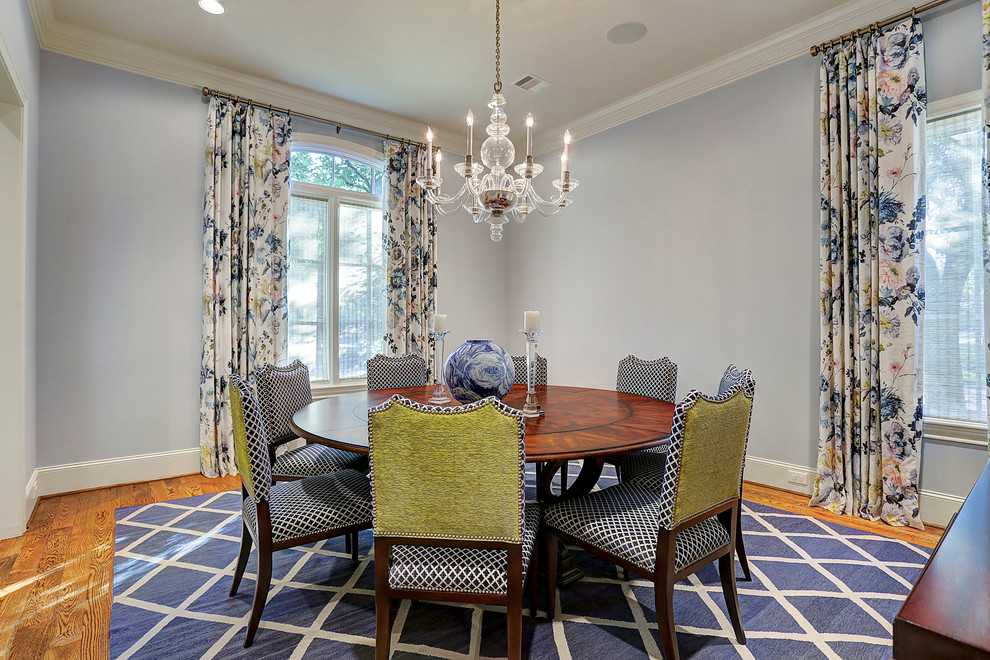 Mid-sized traditional separate dining room in Houston with blue walls, medium hardwood floors, no fireplace and brown floor.