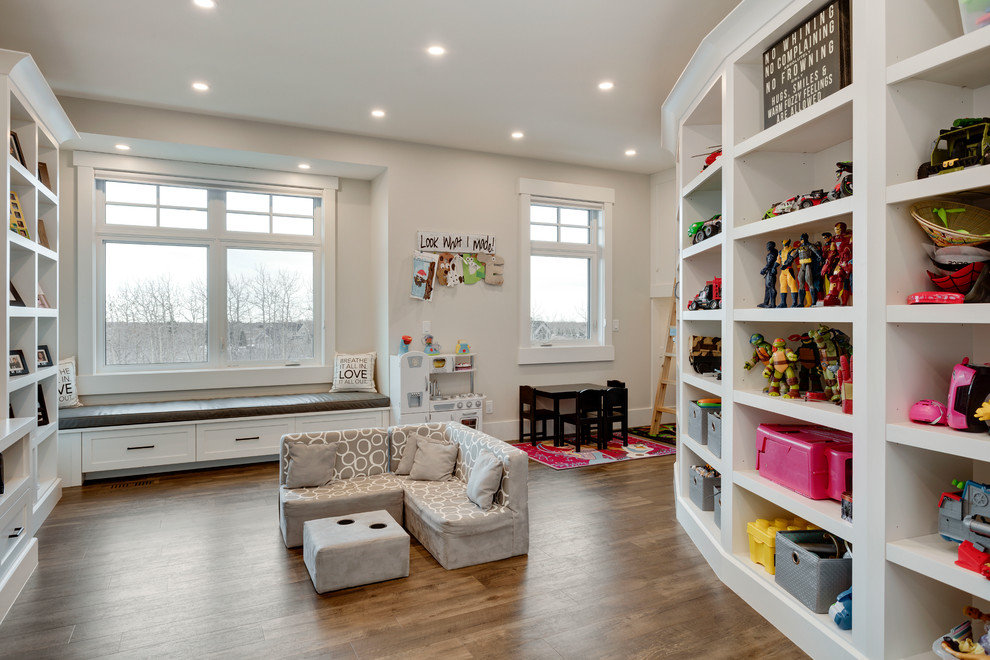 Expansive transitional gender-neutral kids' playroom in Calgary with grey walls, vinyl floors and brown floor for kids 4-10 years old.