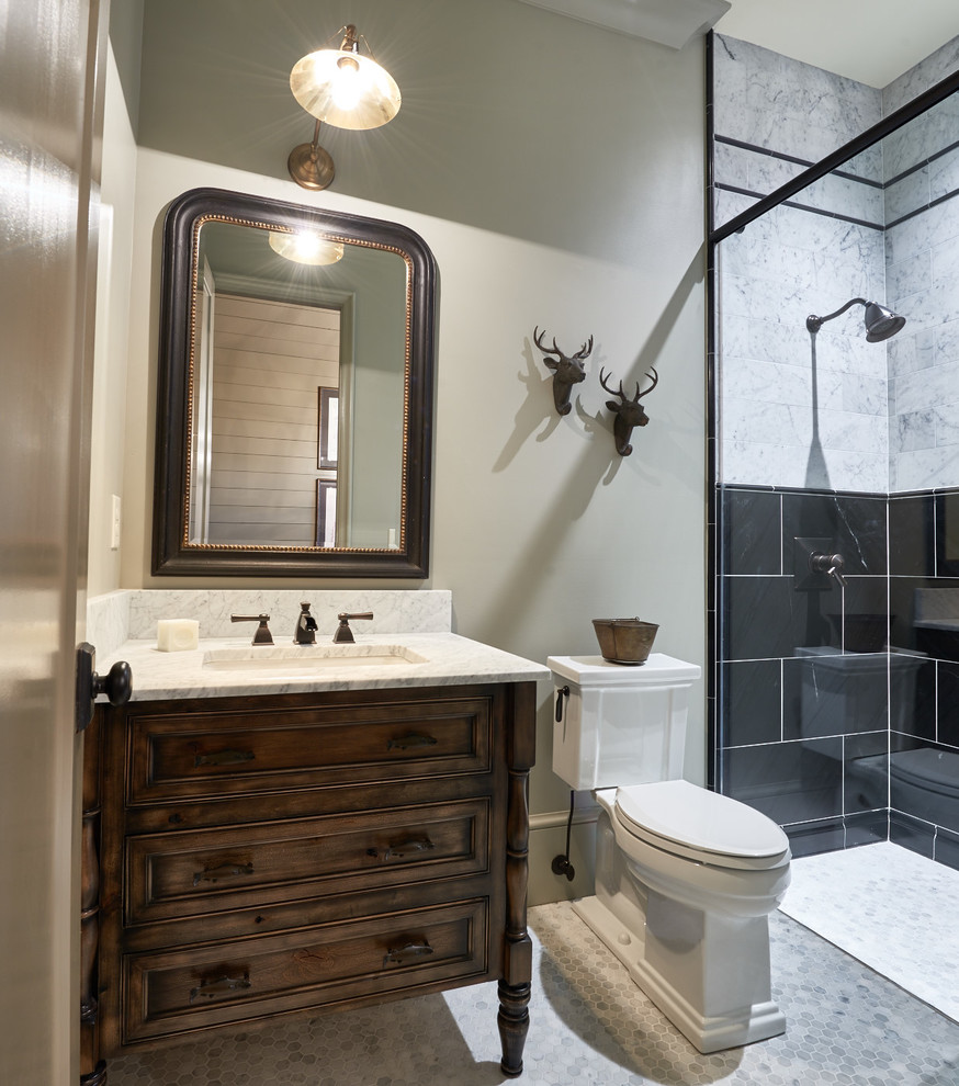 Inspiration for a mid-sized transitional master bathroom in Charlotte with dark wood cabinets, a curbless shower, a two-piece toilet, black tile, subway tile, beige walls, terra-cotta floors, a drop-in sink, solid surface benchtops and beaded inset cabinets.