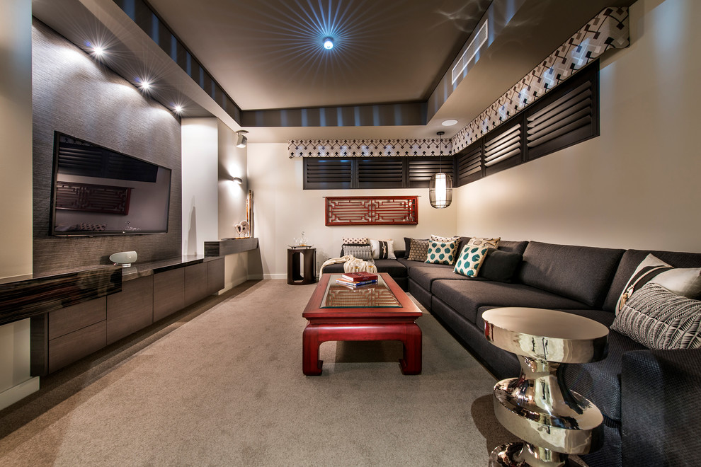 This is an example of a mid-sized eclectic enclosed home theatre in Perth with beige walls, carpet, a built-in media wall and grey floor.