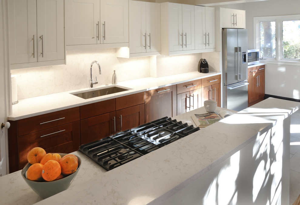 Mid-sized transitional galley porcelain tile eat-in kitchen photo in DC Metro with an undermount sink, shaker cabinets, medium tone wood cabinets, quartzite countertops, white backsplash, stone tile backsplash, stainless steel appliances and beige walls
