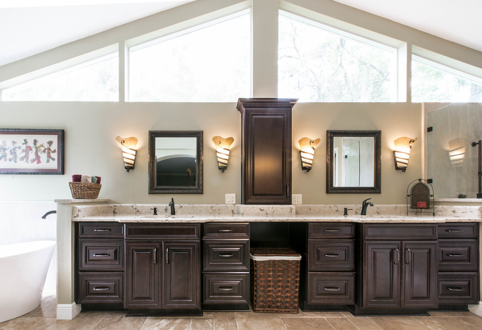 This is an example of a large traditional master bathroom in Orlando with raised-panel cabinets, brown cabinets, a corner shower, multi-coloured tile, porcelain tile, travertine floors, an undermount sink, engineered quartz benchtops and multi-coloured floor.