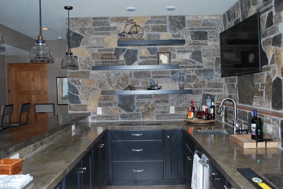 Example of a mid-sized mountain style galley ceramic tile enclosed kitchen design with an undermount sink, shaker cabinets, blue cabinets, concrete countertops, multicolored backsplash, stainless steel appliances and a peninsula
