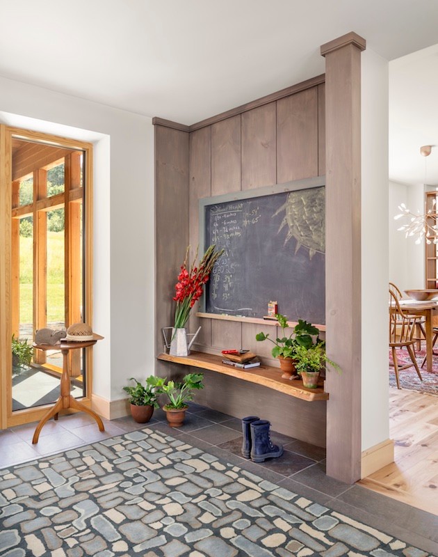This is an example of a mid-sized contemporary foyer in Portland Maine with ceramic floors and grey floor.