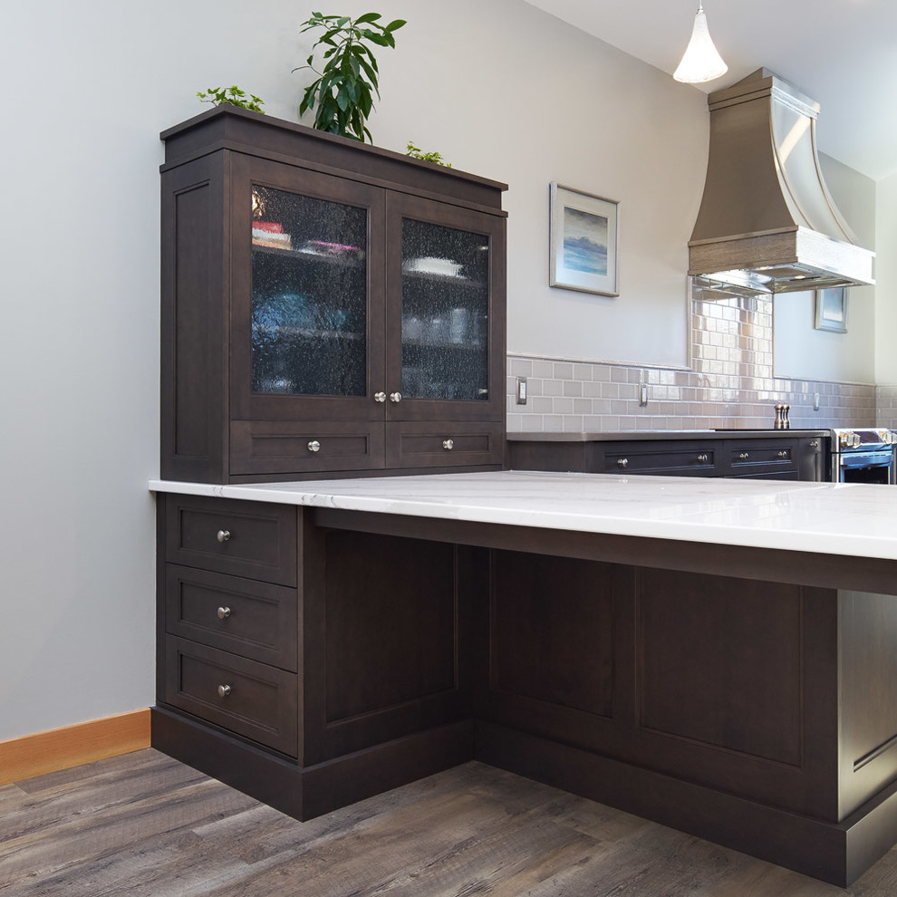 Inspiration for a small transitional u-shaped medium tone wood floor and gray floor open concept kitchen remodel in Calgary with an undermount sink, recessed-panel cabinets, dark wood cabinets, quartz countertops, gray backsplash, subway tile backsplash, stainless steel appliances and a peninsula
