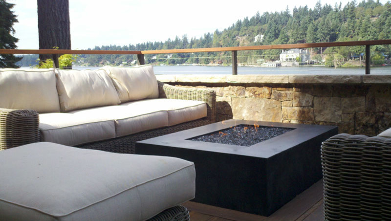 This is an example of a mid-sized contemporary backyard patio in Portland with a fire feature, no cover and decking.