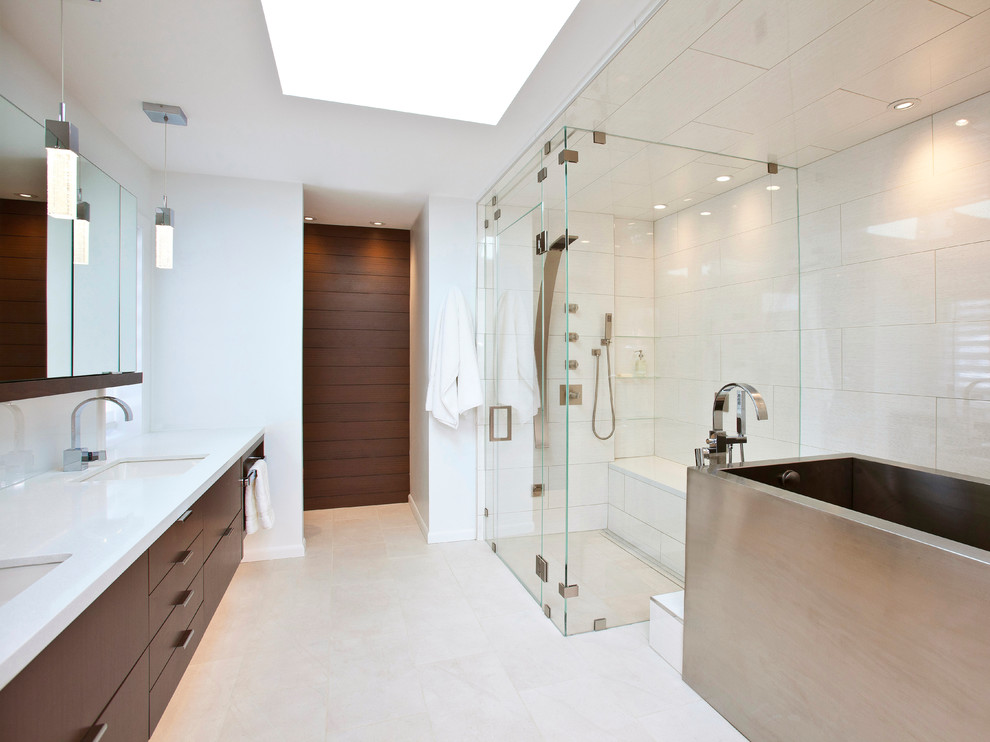 This is an example of a mid-sized modern master bathroom in Cincinnati with flat-panel cabinets, dark wood cabinets, engineered quartz benchtops, an undermount sink, a japanese tub, a curbless shower, white tile, porcelain tile and white walls.