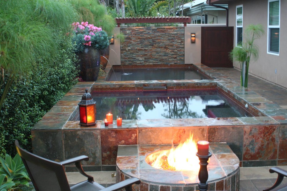Example of a small transitional backyard tile and custom-shaped natural pool landscaping design in Orange County