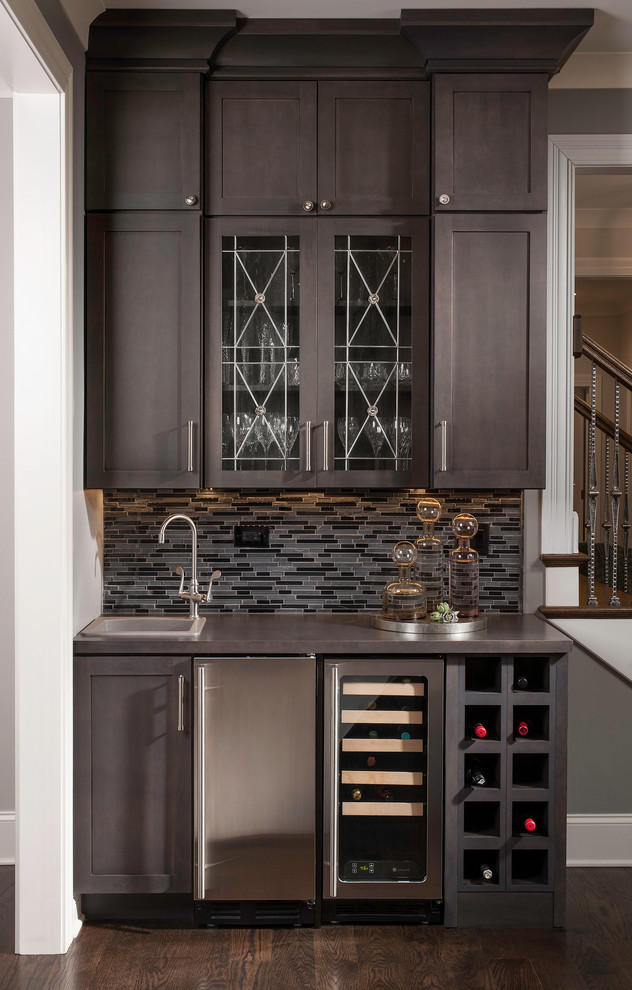 Photo of a transitional home bar in Chicago with dark hardwood floors.