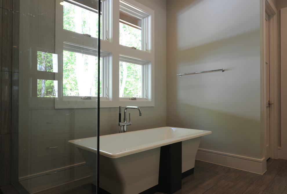 Large transitional master gray tile and porcelain tile porcelain tile freestanding bathtub photo with an undermount sink, shaker cabinets, white cabinets, quartzite countertops, a two-piece toilet and gray walls