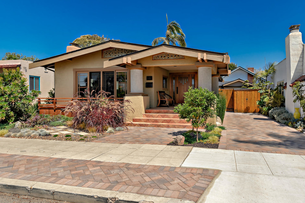 Photo of a mid-sized transitional stucco beige exterior in San Diego.