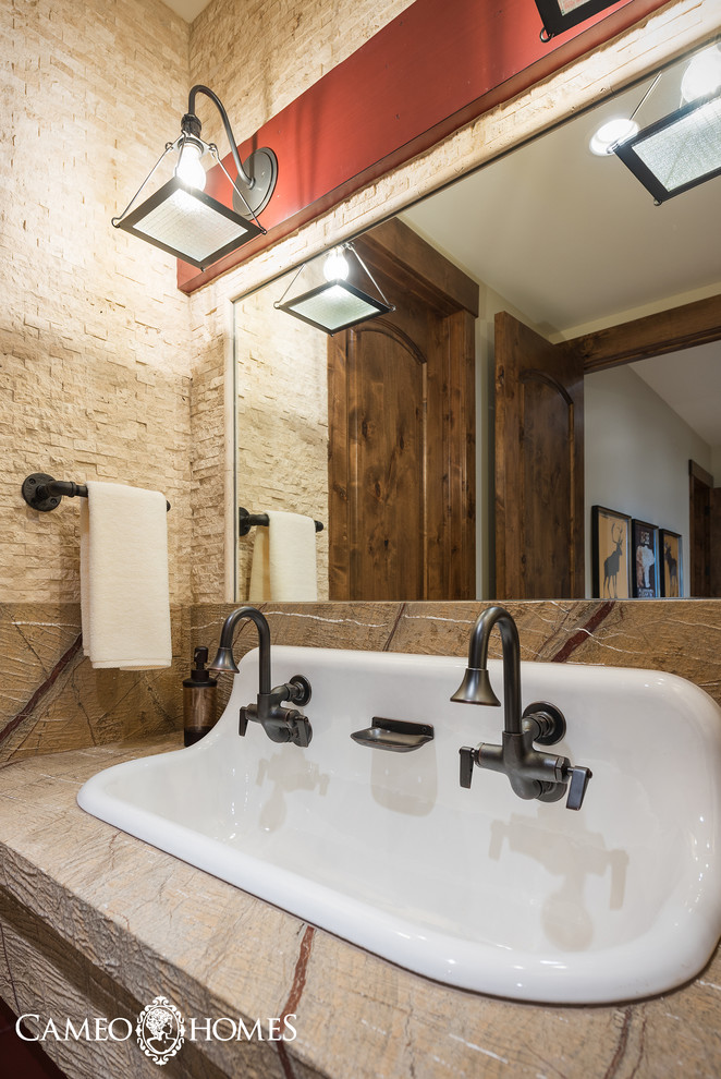 Small country kids bathroom in Salt Lake City with a trough sink, marble benchtops, flat-panel cabinets, dark wood cabinets, beige tile, stone tile, white walls and porcelain floors.