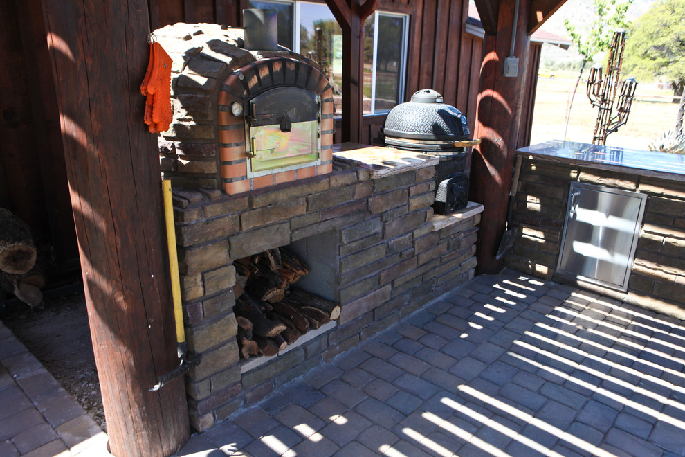 Design ideas for a mid-sized country backyard patio in Phoenix with an outdoor kitchen, concrete pavers and a pergola.