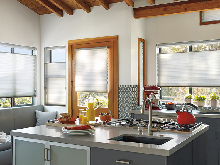 Inspiration for a mid-sized transitional l-shaped enclosed kitchen remodel in Phoenix with a double-bowl sink, raised-panel cabinets, light wood cabinets, tile countertops, multicolored backsplash, mosaic tile backsplash, stainless steel appliances and an island