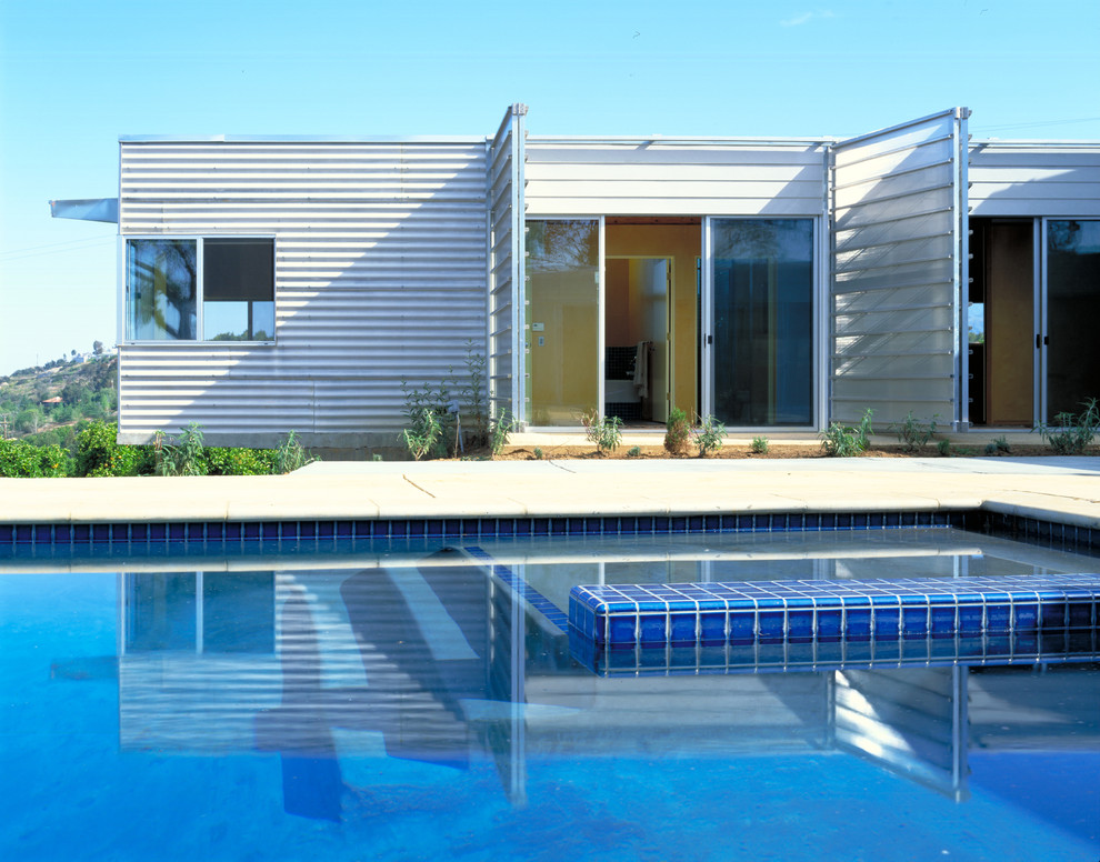 Inspiration for a contemporary one-storey exterior in Other with metal siding and a flat roof.