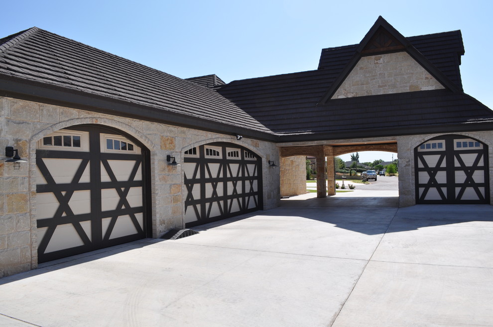 This is an example of a large transitional attached four-car garage in Austin.