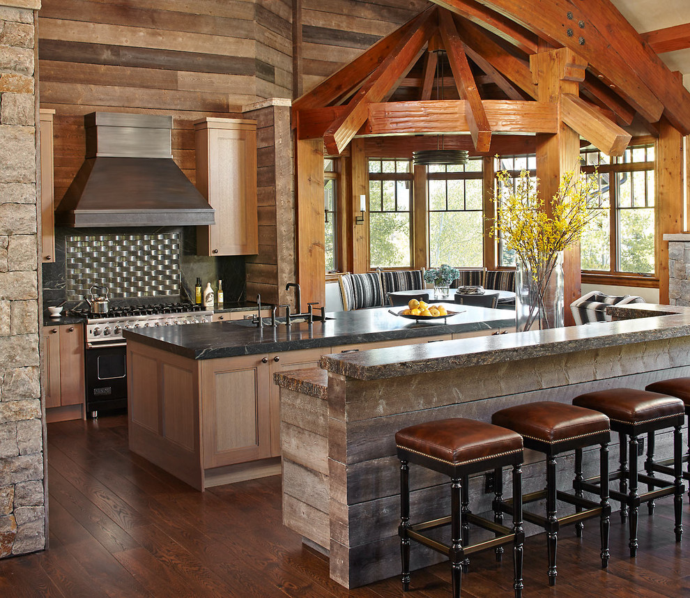 Country galley eat-in kitchen in Denver with recessed-panel cabinets, medium wood cabinets, black splashback, black appliances, dark hardwood floors and multiple islands.