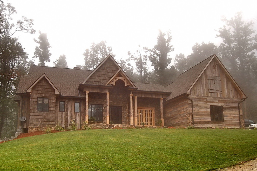 Inspiration for a huge rustic brown two-story wood gable roof remodel with a tile roof
