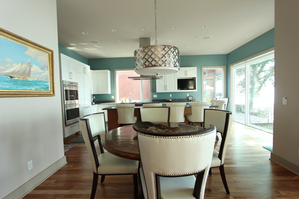 Inspiration for a mid-sized transitional light wood floor great room remodel with gray walls