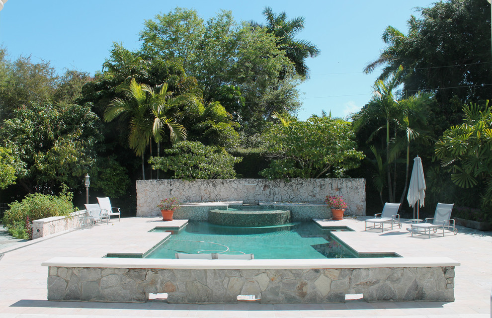 Photo of a tropical custom-shaped pool in Miami.
