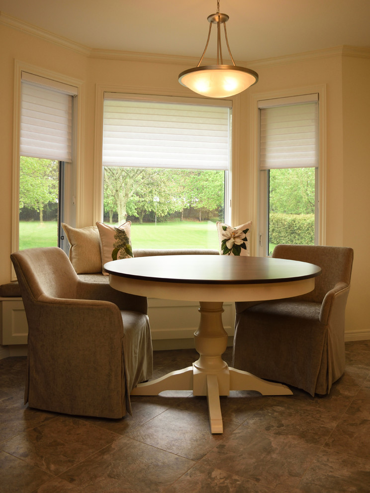 Eat-in kitchen - mid-sized transitional u-shaped vinyl floor and multicolored floor eat-in kitchen idea with an undermount sink, yellow cabinets, solid surface countertops, multicolored backsplash, stainless steel appliances and no island