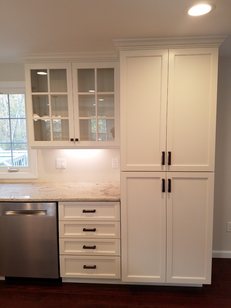 Eat-in kitchen - mid-sized transitional l-shaped dark wood floor and brown floor eat-in kitchen idea with a farmhouse sink, shaker cabinets, white cabinets, granite countertops, white backsplash, subway tile backsplash, stainless steel appliances and an island