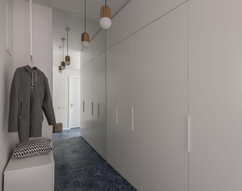 Design ideas for a mid-sized scandinavian entry hall in Moscow with white walls, ceramic floors and blue floor.